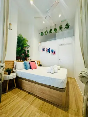 a bedroom with a large bed with plants on the wall at Nice & Cozy Flat Close The Beach in Valencia