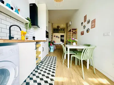 a kitchen and dining room with a table and chairs at Nice & Cozy Flat Close The Beach in Valencia
