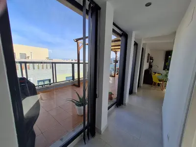 a room with a balcony with a view of the ocean at Attic terrace 360 Moncofa in Moncófar