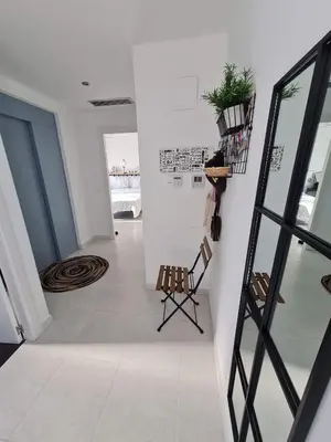 a hallway with a staircase and chairs in a building at Attic terrace 360 Moncofa in Moncófar