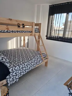 a bunk bed in a room with a window at Attic terrace 360 Moncofa in Moncófar