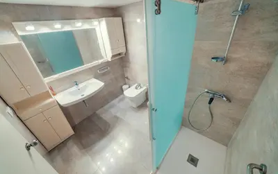 a bathroom with a shower and a sink and a toilet at Apartamento familiar Port-Saplaya in Port Saplaya