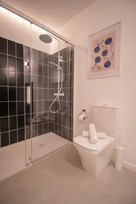 a bathroom with a toilet and a glass shower at Breathe Apartments by Concept Flats in Valencia