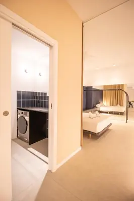 a view of a bedroom with a bed and a bathroom at Breathe Apartments by Concept Flats in Valencia