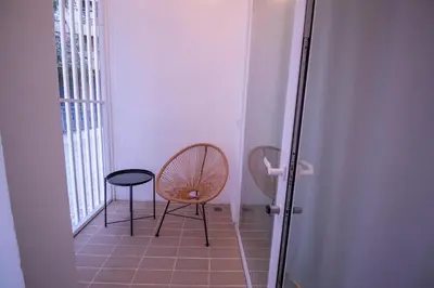 a hallway with a chair and a stool in a room at Breathe Apartments by Concept Flats in Valencia