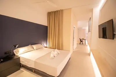 a bedroom with a white bed with a black wall at Breathe Apartments by Concept Flats in Valencia