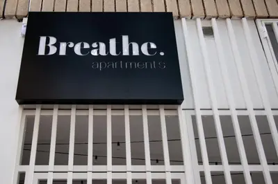 a sign on the side of a building at Breathe Apartments by Concept Flats in Valencia