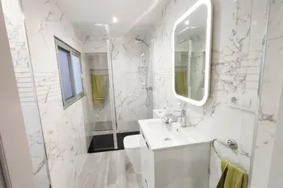 a white bathroom with a sink and a mirror at District Key - Lliria, Santisima Sangre in Lliria
