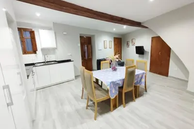 a kitchen and dining room with a table and chairs at District Key - Lliria, Santisima Sangre in Lliria