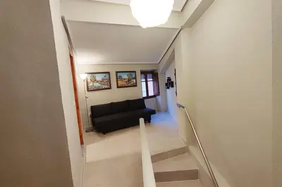 a view of a living room with a black couch at District Key - Lliria, Santisima Sangre in Lliria