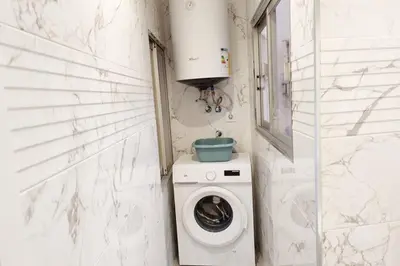 a small bathroom with a washing machine in it at District Key - Lliria, Santisima Sangre in Lliria