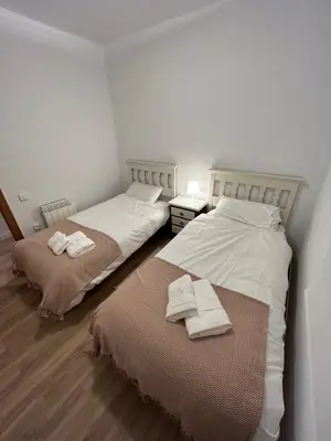 two beds sitting next to each other in a room at Frente al puerto y junto a la playa del Arenal in Burriana