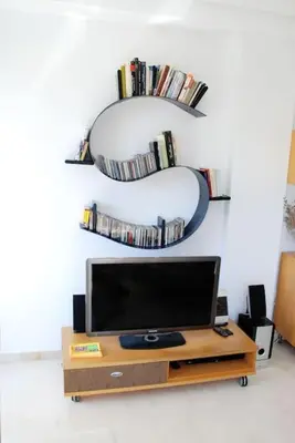 a flat screen tv sitting in a living room with two shelves at Valencia las Artes y Ciencias + Garaje + Netflix in Valencia
