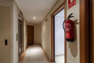 a fire hydrant hanging on the wall of a hallway at Valencia las Artes y Ciencias + Garaje + Netflix in Valencia