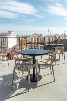 a table and chairs on top of a roof at Limehome Valencia Carrer de Sant Jacint in Valencia