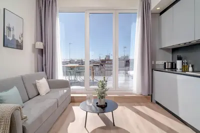 a living room with a couch and a table at Limehome Valencia Carrer de Sant Jacint in Valencia