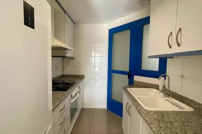 a small kitchen with a sink and a stove at Apto. luminoso con vistas en playa de La Patacona in Valencia