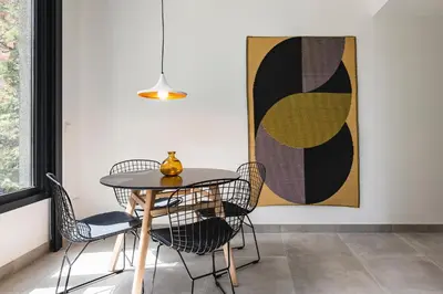a table and chairs in a room with a painting at Valencia Apartments by Olala Homes in Valencia
