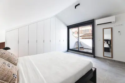 a bedroom with a large bed and a large window at Valencia Apartments by Olala Homes in Valencia