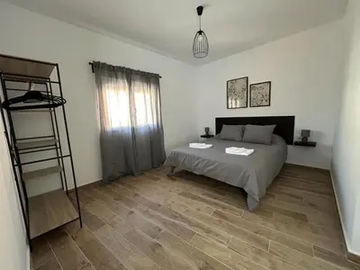 a bedroom with a bed and a wooden floor at CAN´SELMA 1 in Chella