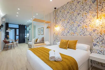 a bedroom with a large bed with towels on it at FLORIT FLATS - The Joaquin Sorolla Station Apartments in Valencia
