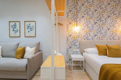a living room with a couch and a table at FLORIT FLATS - The Joaquin Sorolla Station Apartments in Valencia