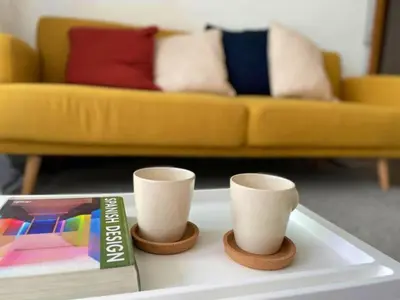 a tray with two cups and a book on a table at Apto con vistas a la playa de La Patacona in Valencia
