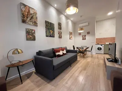 a living room with a couch and a table at Mestalla Garden in Valencia