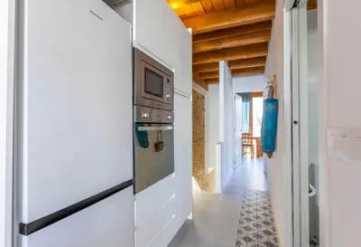 a kitchen with a refrigerator and a microwave at Mediterranean Gem Getaway in Valencia