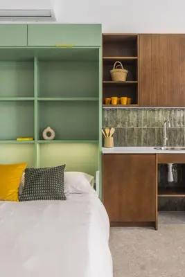 a bedroom with a bed and a kitchen at Green suite by Concept Flats in Valencia