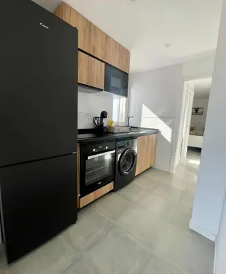 a kitchen with a black refrigerator and a dishwasher at UIM Mediterraneo ATICO Cendoya Wifi in Puerto de Sagunto