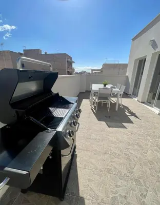 a patio with a grill and a table on a roof at UIM Mediterraneo ATICO Cendoya Wifi in Puerto de Sagunto