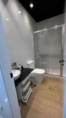 a bathroom with a shower and a toilet and a sink at Beach Valencia Rooms Late Checkout 14 h free Netflix Tv in Valencia