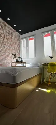 a bedroom with a bed and a brick wall at Beach Valencia Rooms Late Checkout 14 h free Netflix Tv in Valencia
