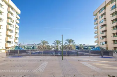 a parking lot with palm trees in front of buildings at SAPORE DI MARE in Valencia