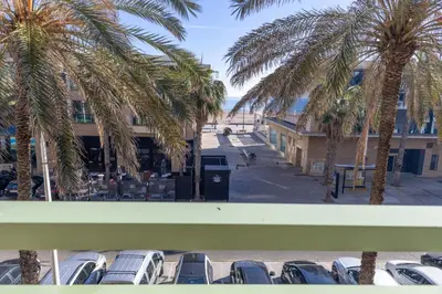 a view from the balcony of a parking lot with palm trees at SAPORE DI MARE in Valencia