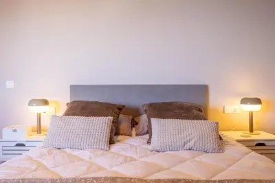 a bedroom with a bed with two lamps on tables at SAPORE DI MARE in Valencia