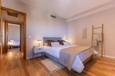 a bedroom with a bed and a table with a lamp at SAPORE DI MARE in Valencia