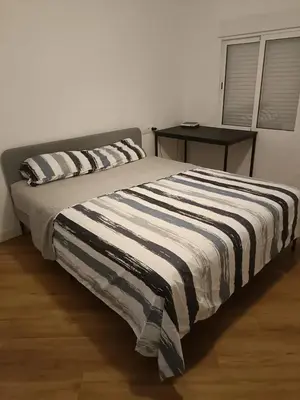 a bed with two pillows on it in a bedroom at habitaciones patraix in Valencia