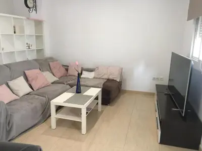 a living room with a couch and a table at Pericos Gilet in Gilet