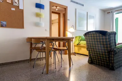 a room with a table and chairs and a bed at Valencia Flat Rental Patacona Beach in Valencia