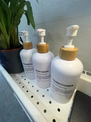three bottles of detergent sitting on a shelf at Valencia Old Town Suite in Valencia
