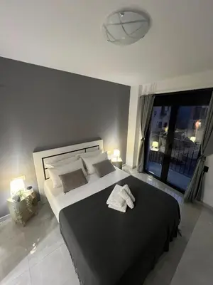 a bedroom with a large bed with two towels on it at Valencia Old Town Suite in Valencia