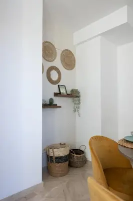 a living room with a chair and baskets on the wall at DormForYou Jose Maria Haro in Valencia