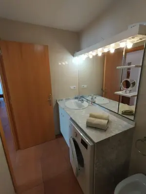 a bathroom with a sink and a toilet and a mirror at Canet estival in Canet de Berenguer