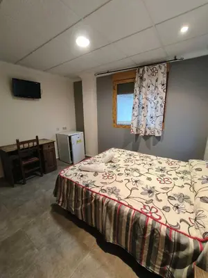 a bedroom with a bed and a window at Ca' La Conchin in Cortez de Pallas