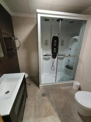 a bathroom with a shower with a phone in it at Ca' La Conchin in Cortez de Pallas
