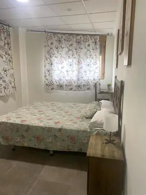 a bedroom with a bed and a window at Ca' La Conchin in Cortez de Pallas