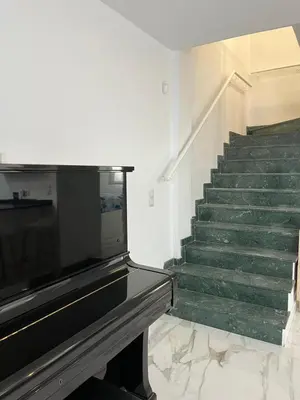 a staircase with green marble floors and a stair case at MAGNÍFICO ADOSADO CERCA DEL MAR in Canet de Berenguer