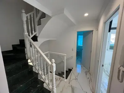 a white staircase in a home with black and white marble floors at MAGNÍFICO ADOSADO CERCA DEL MAR in Canet de Berenguer